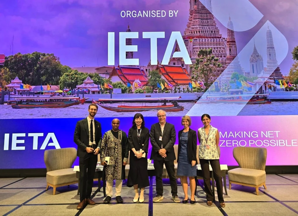 Group photo of panelists at the Asia Climate Summit, hosted by IETA, with a vibrant backdrop of Bangkok’s riverside temples—uniting global leaders to accelerate net-zero goals.