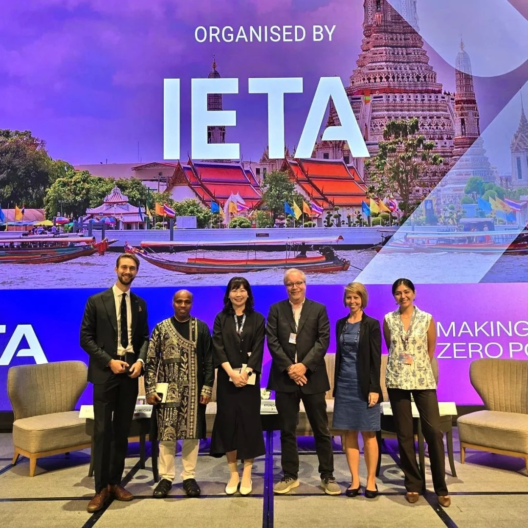 Group photo of panelists at the Asia Climate Summit, hosted by IETA, with a vibrant backdrop of Bangkok’s riverside temples—uniting global leaders to accelerate net-zero goals.